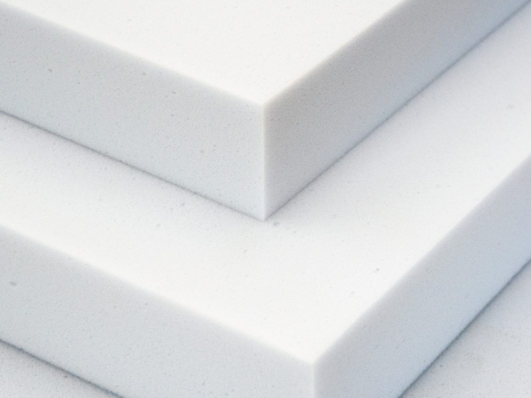 Close-up of the white Basotect B melamine foam - two boards corner to corner with a visible cut edge and open-cell structure