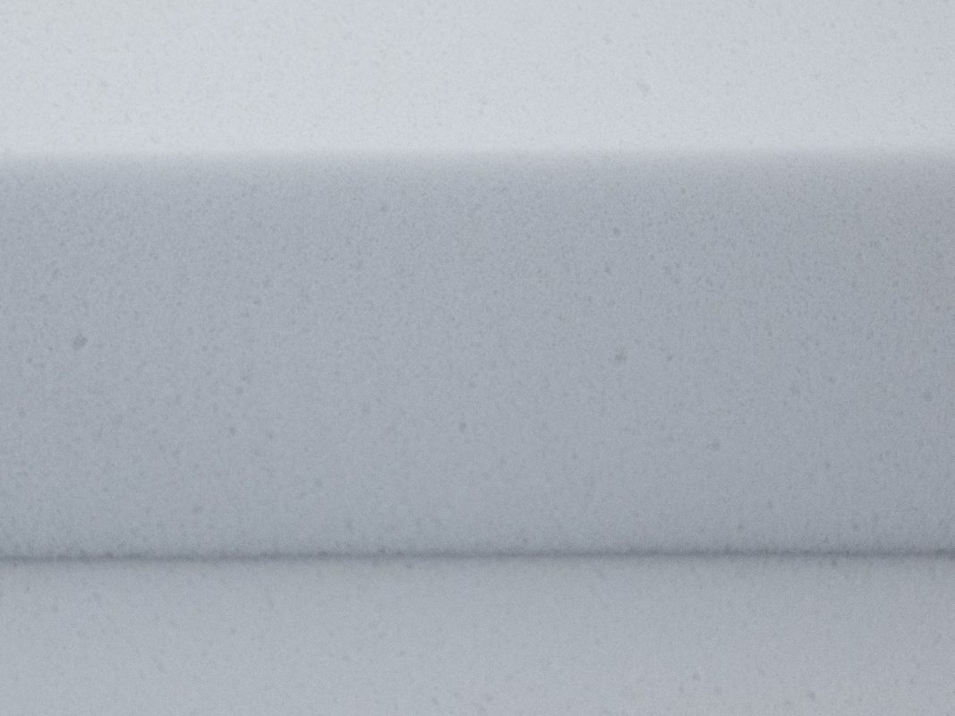 Close-up of the light-grey Basotect G+ melamine foam - a cut edge with the open-cell structure visible