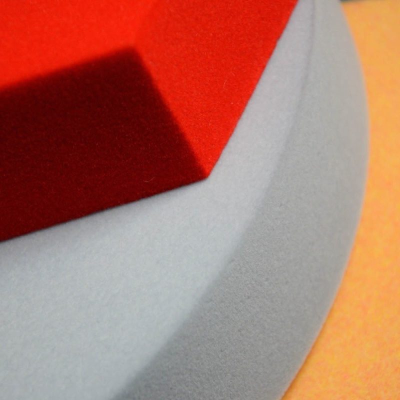 Close-up of the flocked surface of Foamly panels in three colors - red, grey and orange